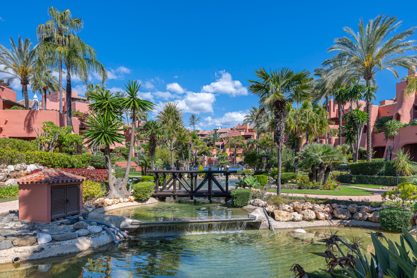 Tropical gardens and lily pond inside a New Golden Mile resort community.